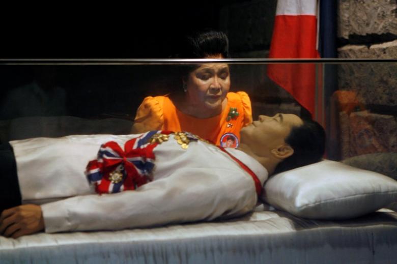 Former Philippine first lady Imelda Marcos visits the glass coffin of her husband, late dictator Ferdinand Marcos, who remains unburied since his death in 1989, in the town of Batac, Ilocos Norte province, north of Manila March 26, 2010.REUTERS/Romeo Ranoco